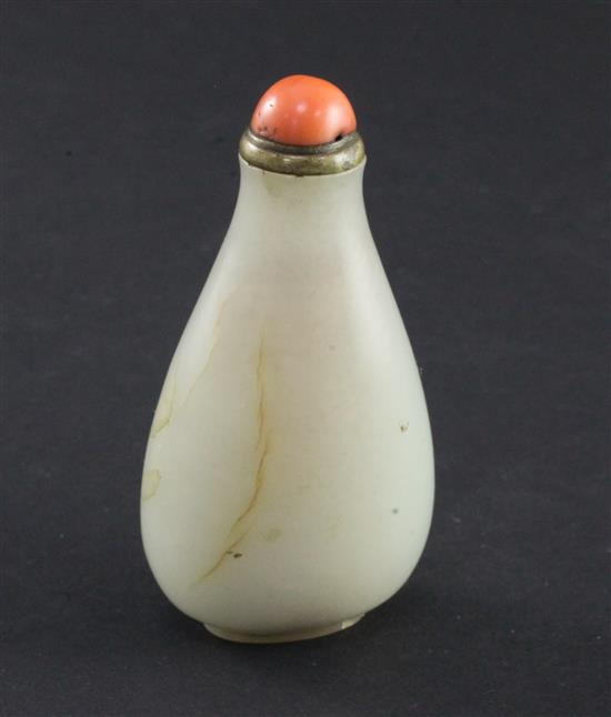 A Chinese pale celadon jade pear shaped snuff bottle, 1750-1850, 6cm, brass and coral stopper